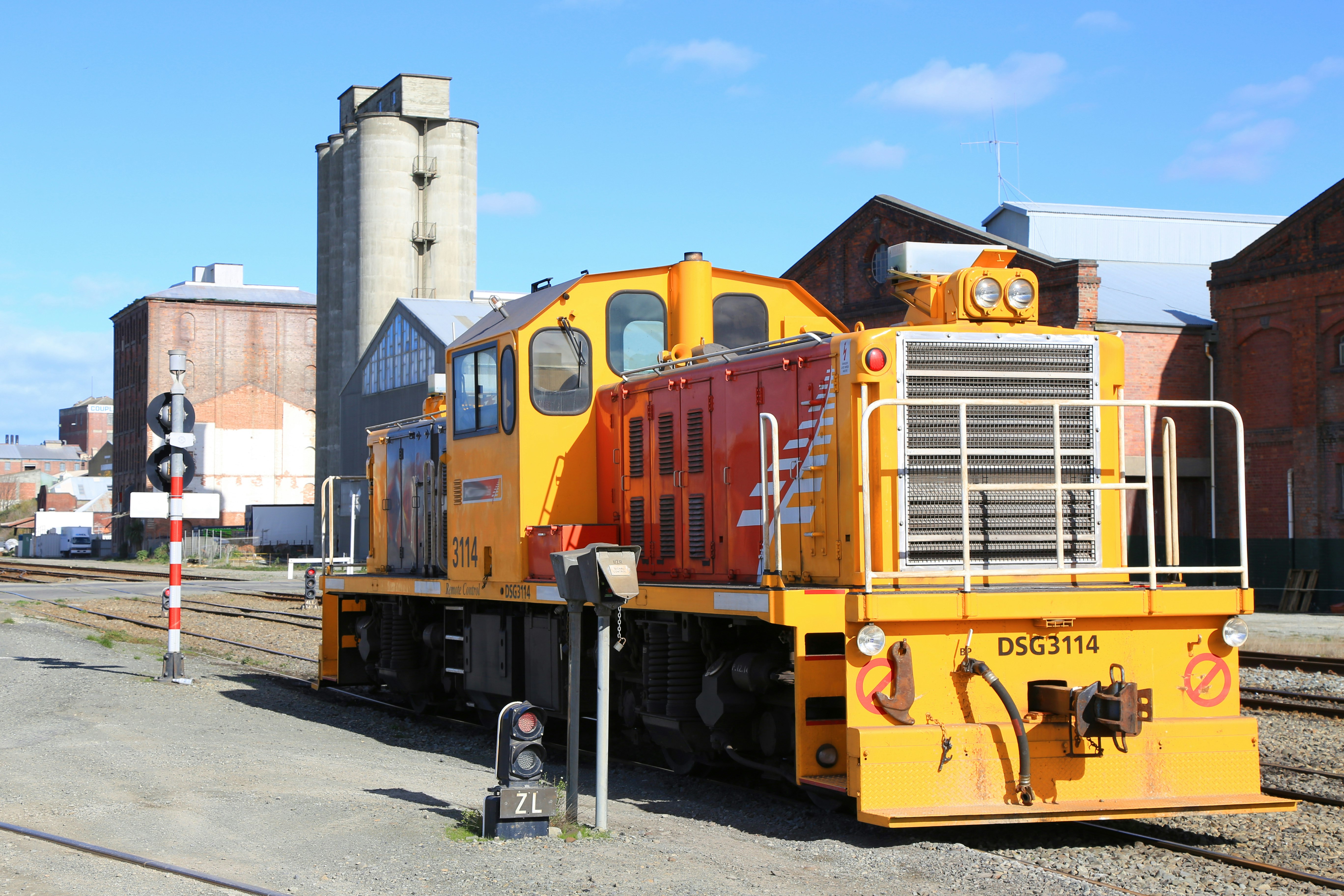 yellow and blue train on rail during daytime